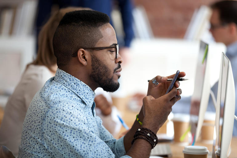 man at work using smartphone